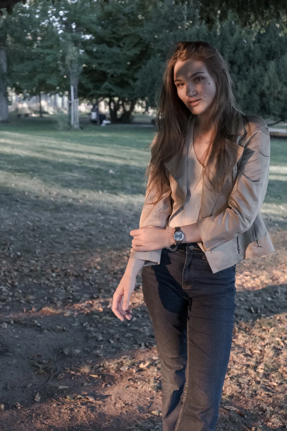 Warm colour portrait beneath trees.