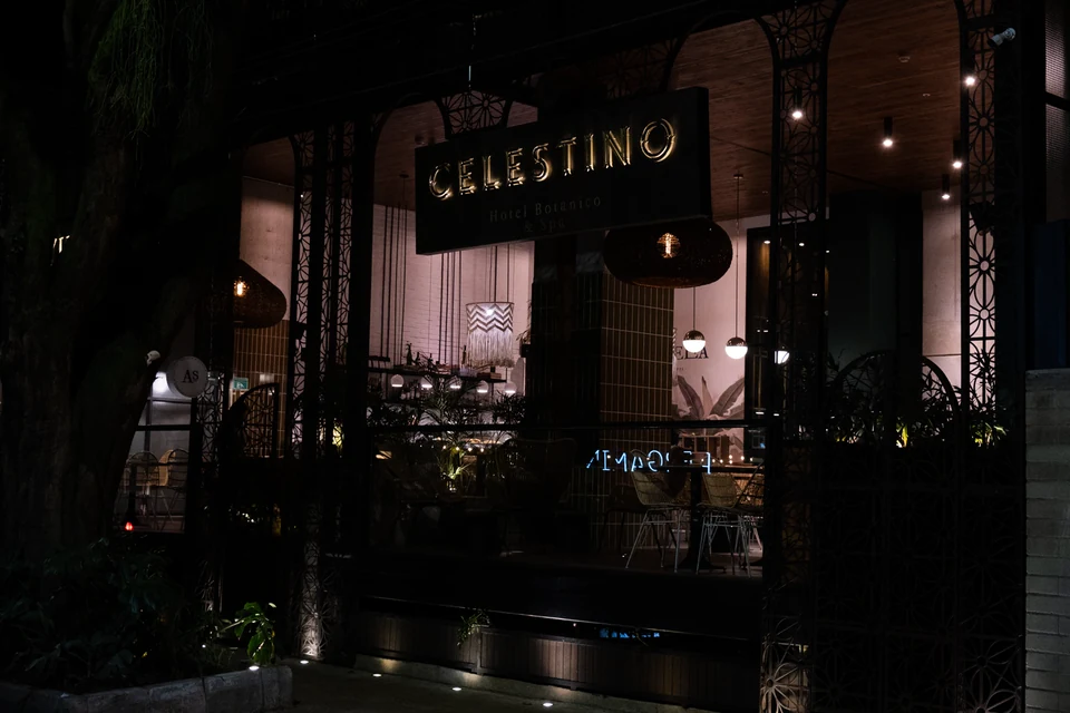 A warmly lit restaurant facade at night.