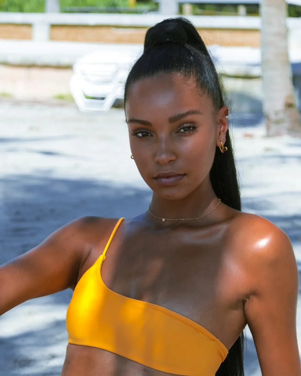 Close portrait in yellow swimwear with warm sunlight on the shoulders.